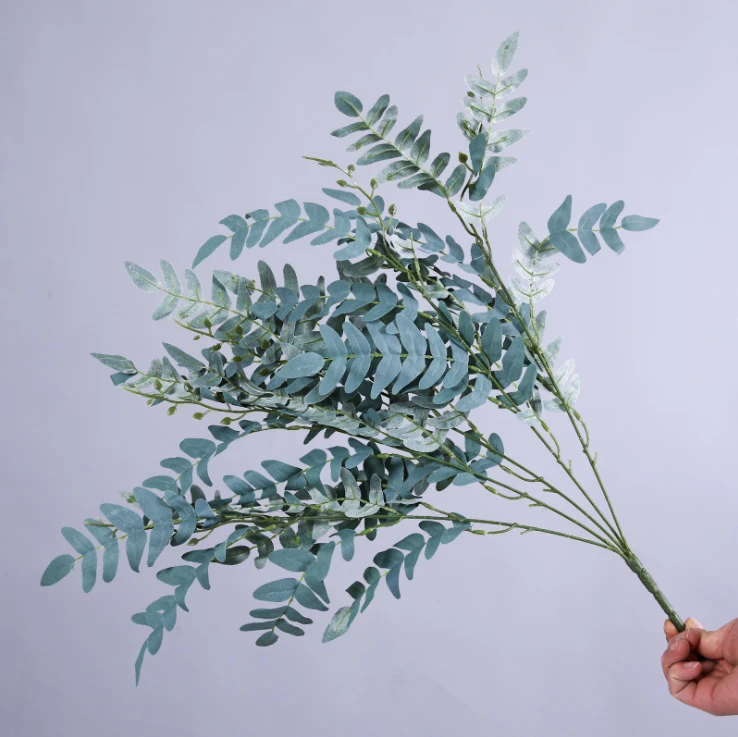 Grey-green artificial foliage sprays spreading from slender stems