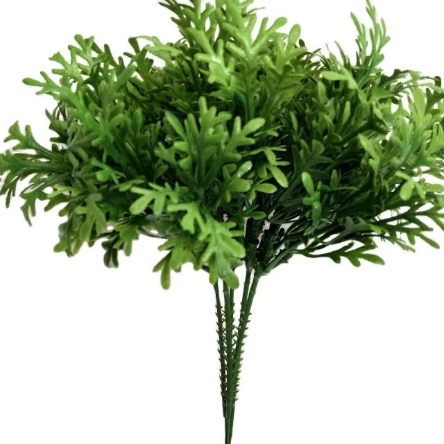 Dense green artificial pine-style foliage branches against a white background