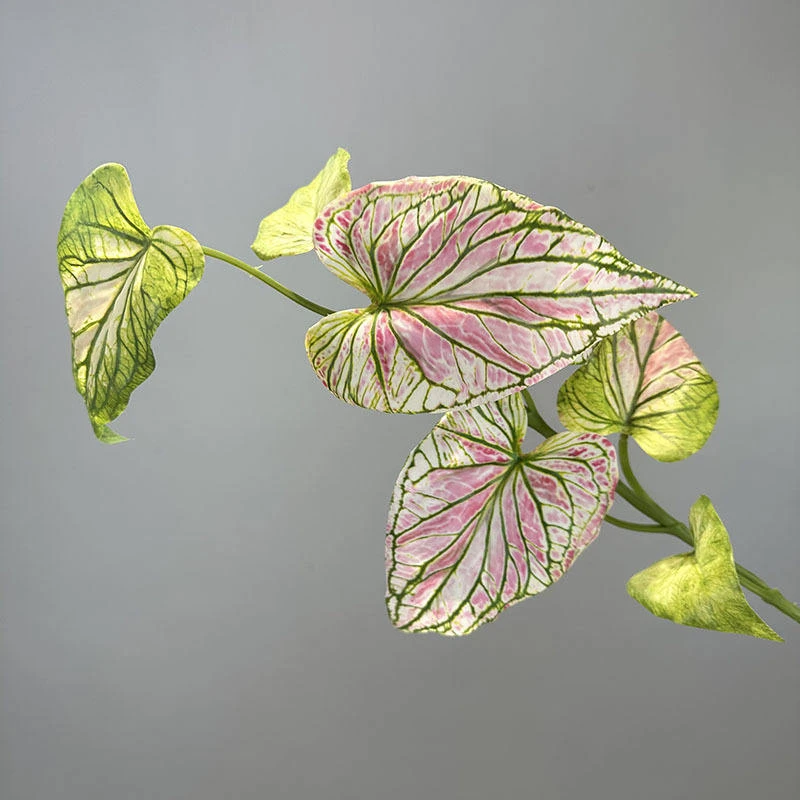Green artificial leaves with pink veins on a decorative spray