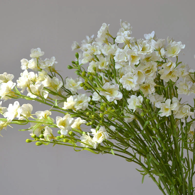 White artificial delphinium sprays gathered into a floral display