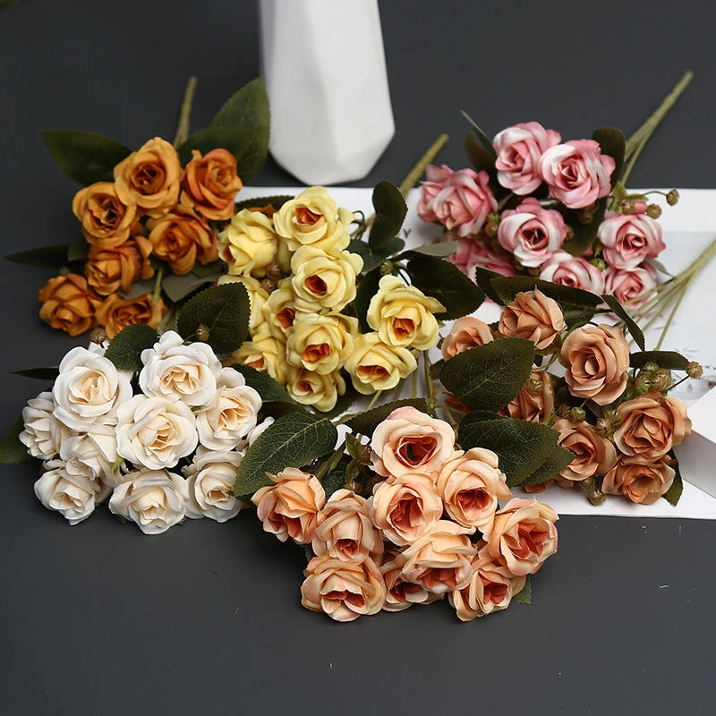 Small artificial rose bunches in cream, pink, peach and brown tones